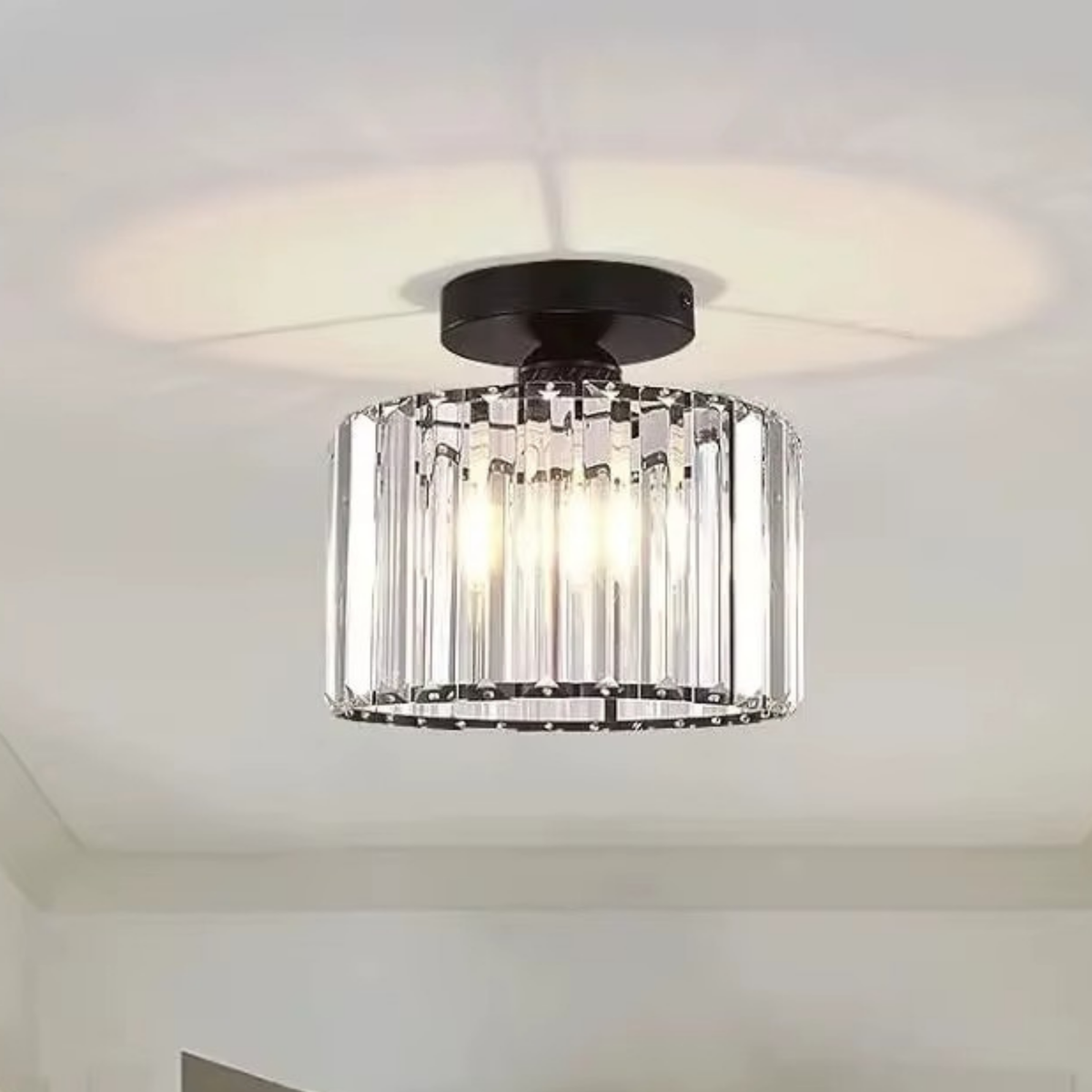 Round crystal bar drum ceiling light with black mount installed on a white ceiling - semi-flush crystal ceiling light - Litora