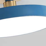 Close-up underside view of blue disc LED ceiling light showing frosted acrylic diffuser panel and brass connector detail - Litora