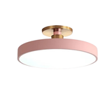 Round pink disc LED semi-flush ceiling light with brass fitting on white background - pastel LED ceiling light for bedroom - Litora