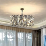 Large round crystal chandelier hanging in a bright luxury living room with floor-to-ceiling windows - statement crystal pendant light - Litora